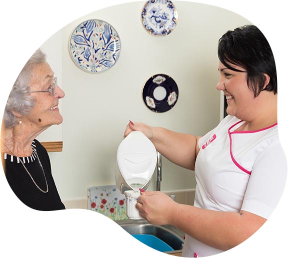 Axe Valley care assistant pouring kettle